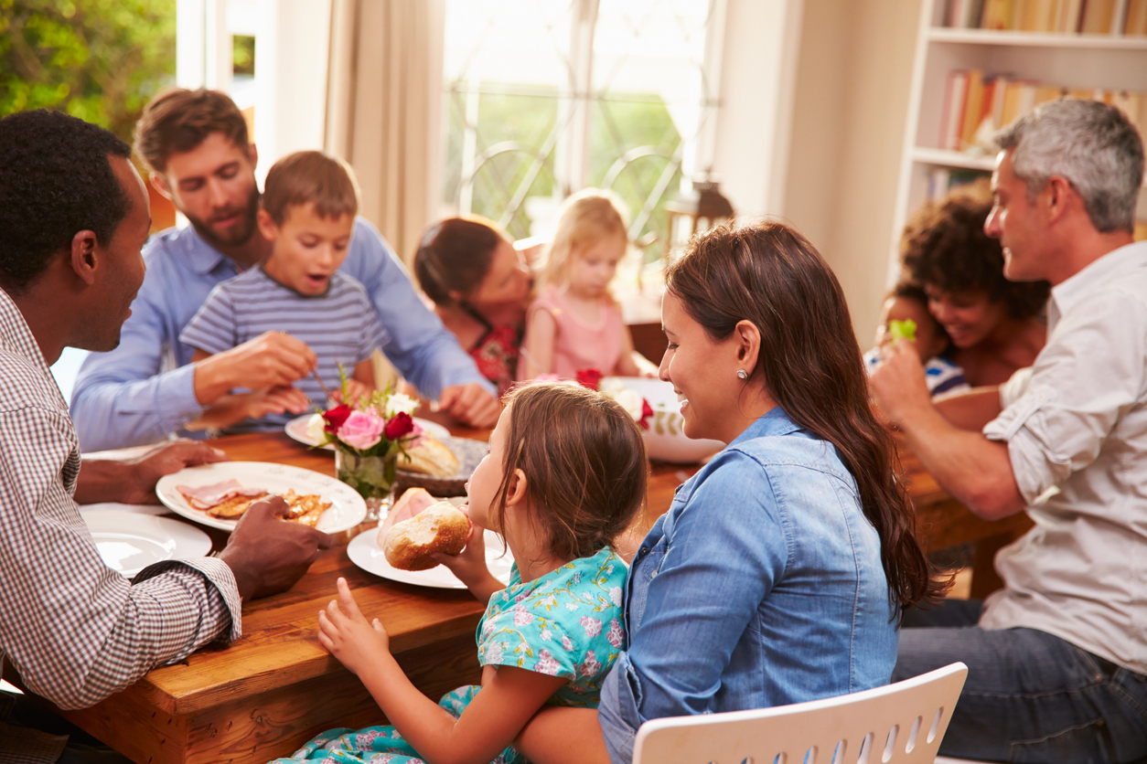 The ADULT Model is demonstrated in the picture by a community of various ages and cultures sitting around a table to share, talk, and laugh